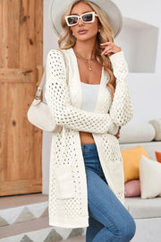 White open-knit pocket cardigan with textured acrylic weave and long sleeves.
