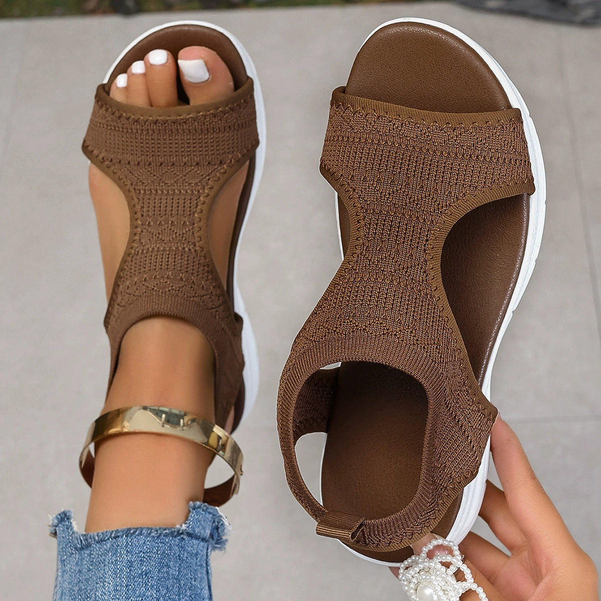 Brown open-toe platform sandals with a knit upper and white sole.