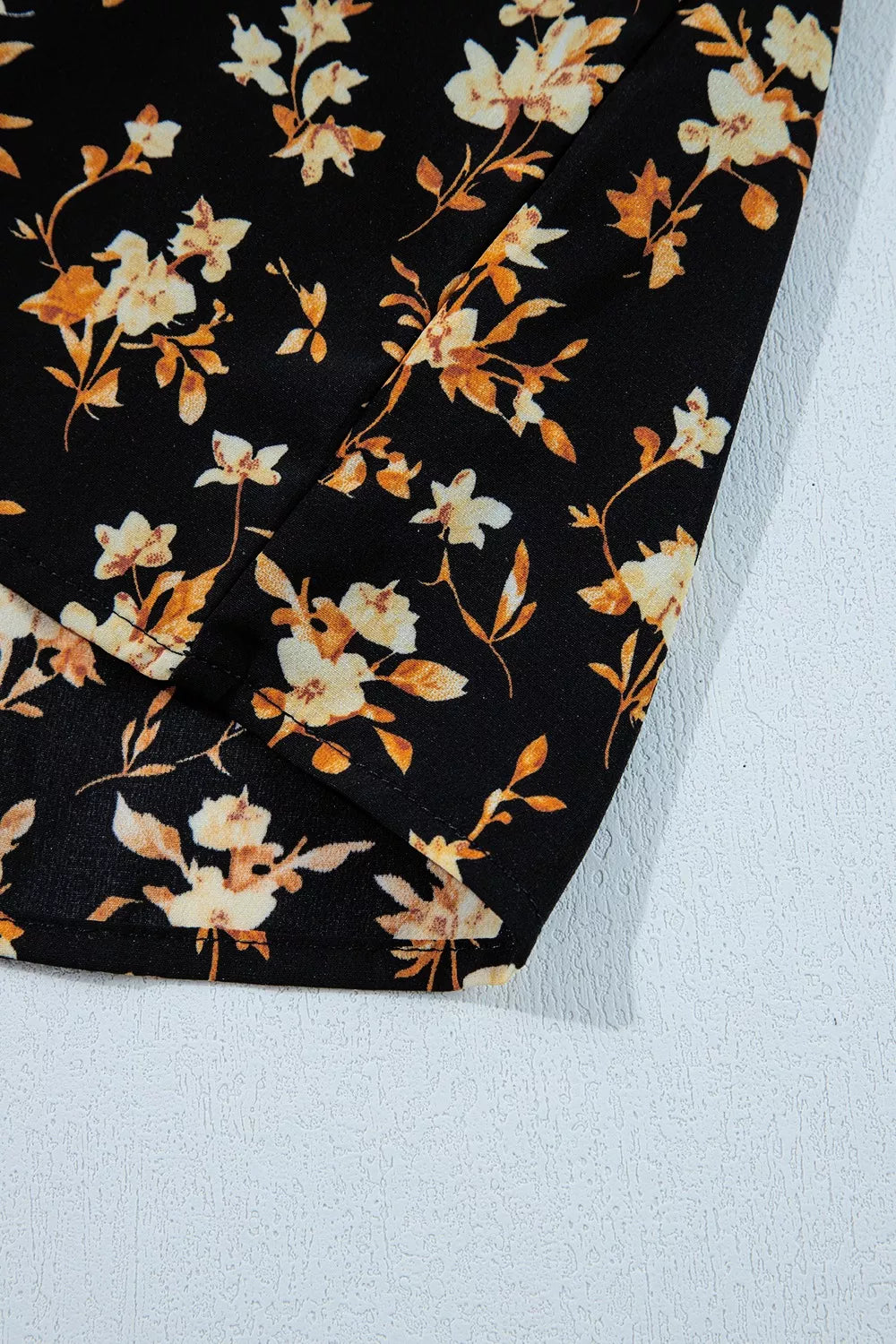 Black floral blouse with smocked waist detail
