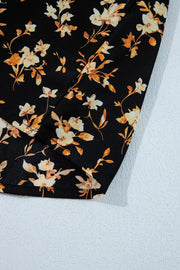 Black floral blouse with smocked waist detail