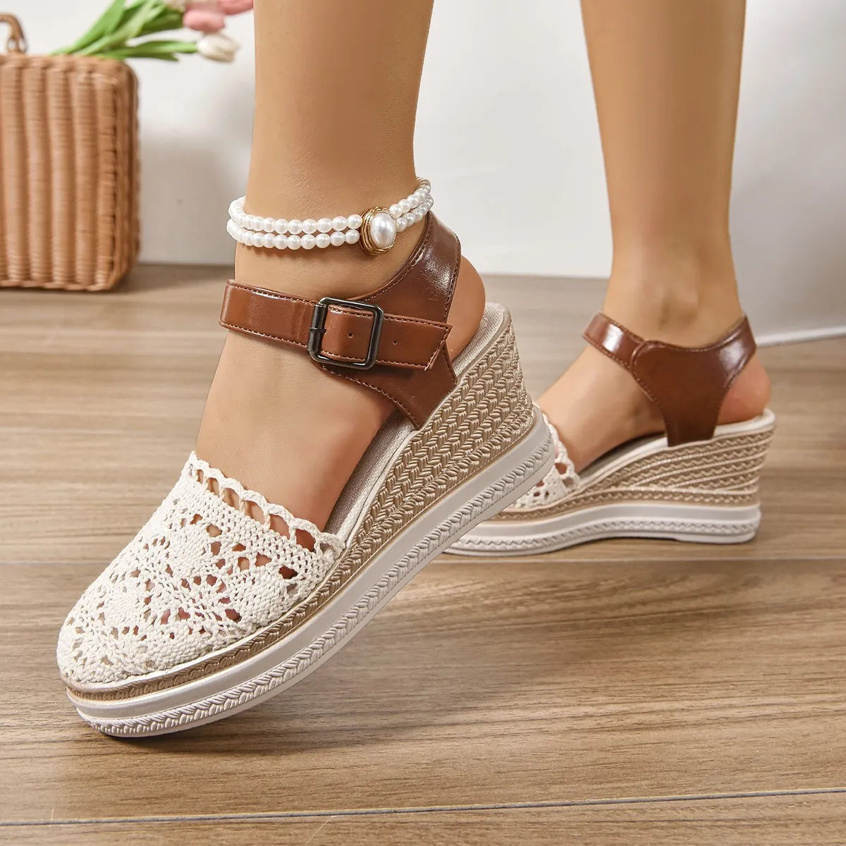 Beige crochet and leather wedge ankle strap sandals with a pearl ankle bracelet.