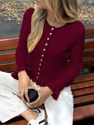 Burgundy acrylic knit cardigan with ruffled trim and buttons, long sleeves.