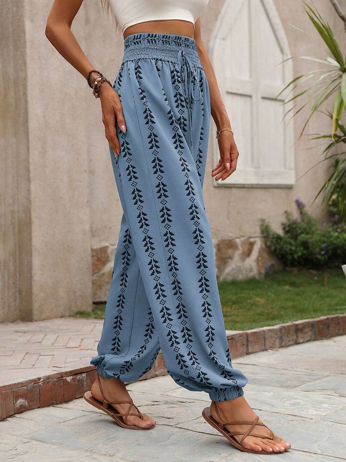 Cerulean gathered ankle trousers with indigo leaf print and drawstring waist.