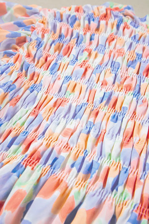 Smocked bodice blouse with a colorful brushstroke print in pastel blue and sherbet tones.