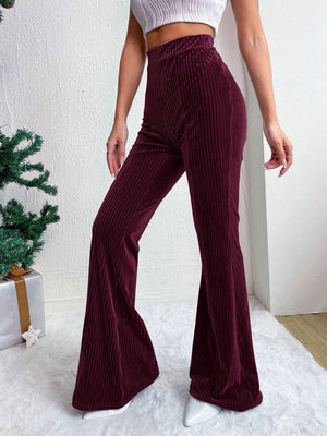Burgundy textured corduroy bell bottom trousers with a high waist.
