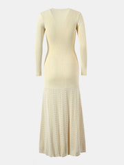 Pastel yellow ribbed knit maxi dress with decorative button detail and patterned skirt.