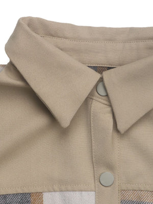 Tan cotton shacket with plaid paneling and button closure detail.