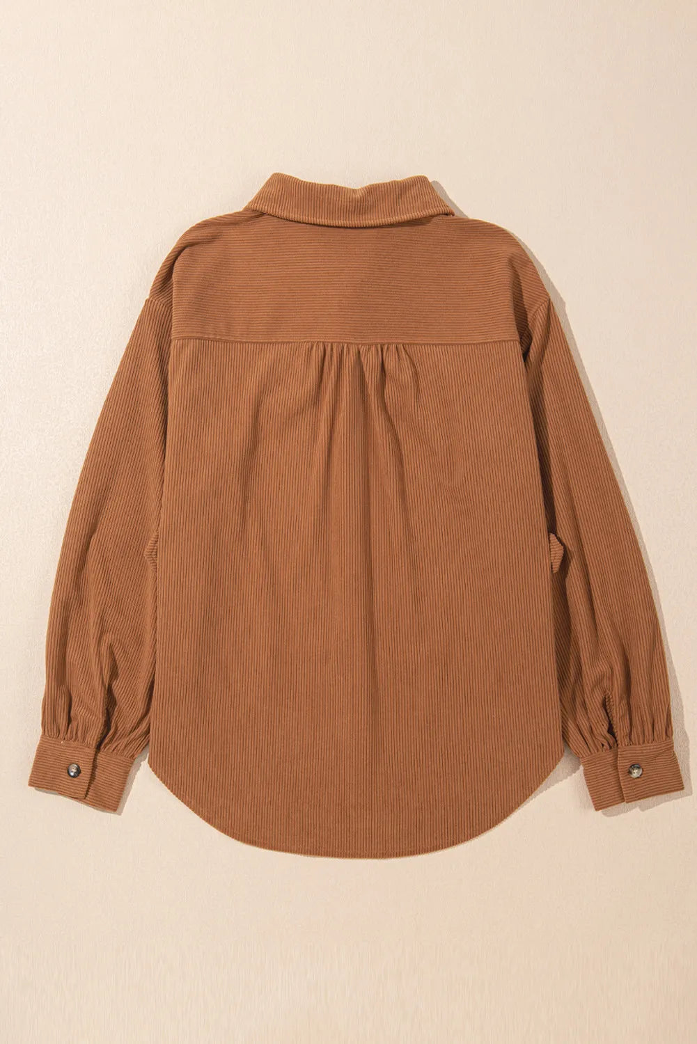 Caramel corduroy shirting jacket with gathered sleeves and buttoned cuffs.