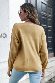 Camel cable knit v-neck pullover sweater with long sleeves.
