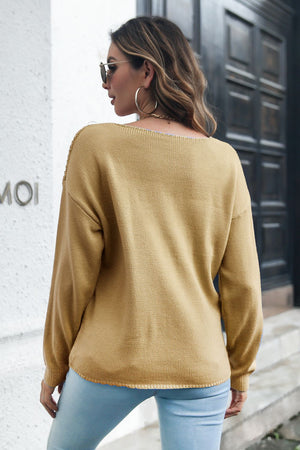 Camel cable knit v-neck pullover sweater with long sleeves.