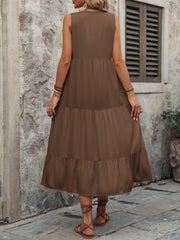 Brown tiered midi sundress with button detail and sleeveless design.