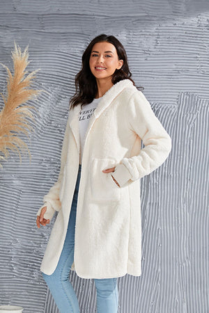 Cream plush hooded duster with thumbhole cuffs and front pockets.