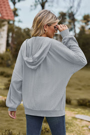 Light Gray textured cable knit zip-up hoodie with a hood and long sleeves.