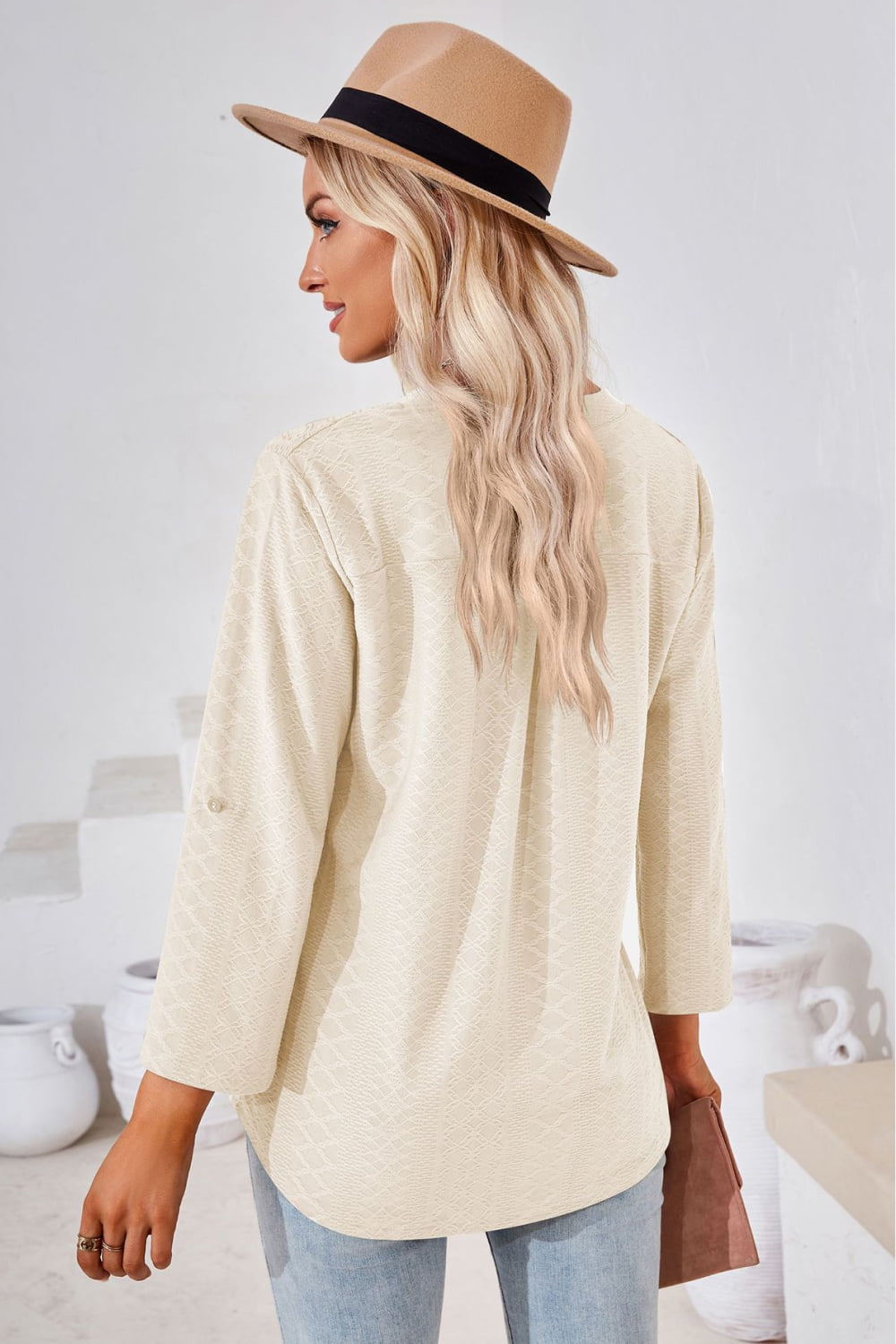 Ivory textured henley blouse with rolled sleeves and a button detail.