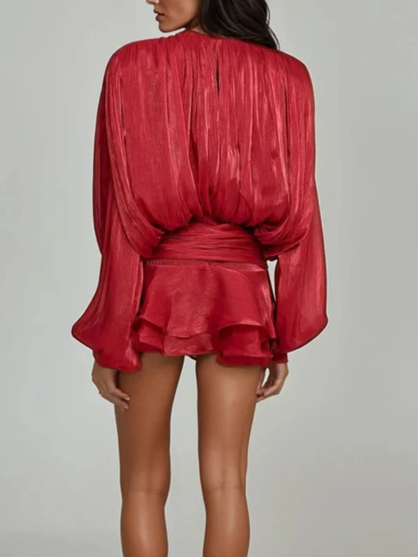 Red two-piece set with balloon sleeves, cinched waist, and ruffled mini skirt.