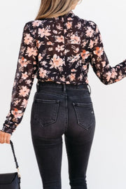Black sheer floral mock neck blouse with long sleeves.