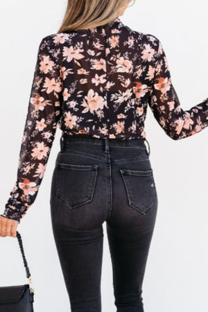 Black sheer floral mock neck blouse with long sleeves.