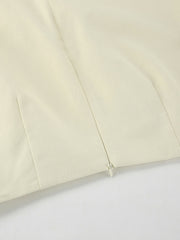 Chic cotton midi skirt in beige with a side zipper detail.