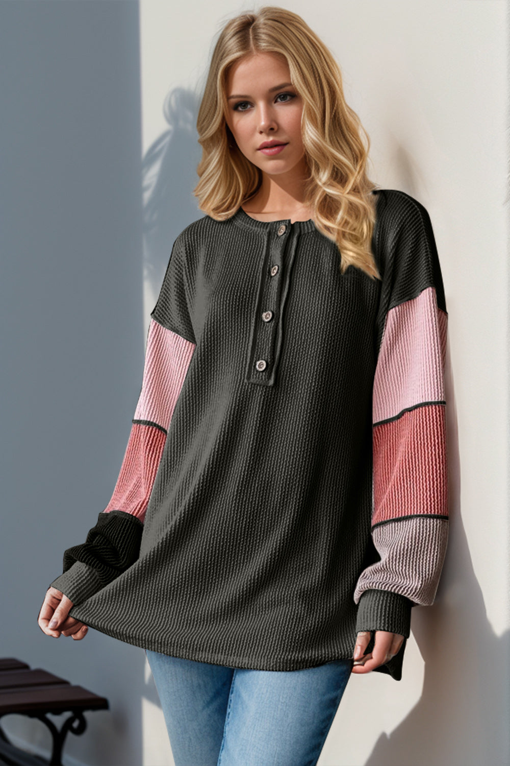 Waffle knit henley shirt in black with colorblock sleeves in pink and coral.