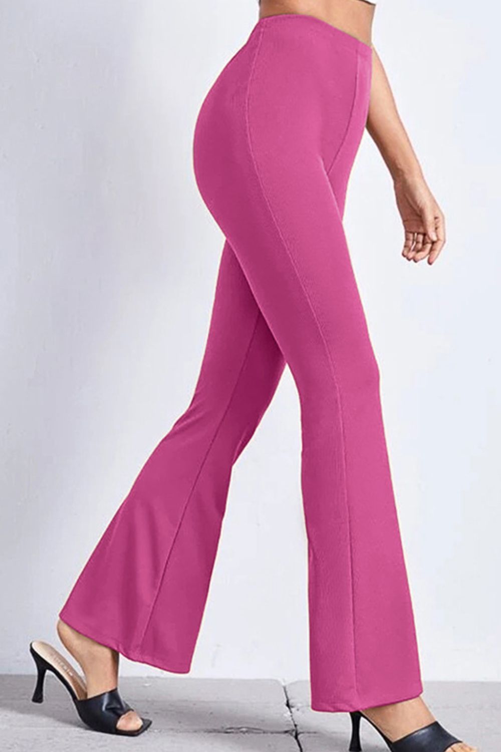 Textured flare leggings in hot pink with a subtle ribbed texture, styled with heels.