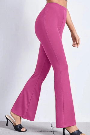 Textured flare leggings in hot pink with a subtle ribbed texture, styled with heels.