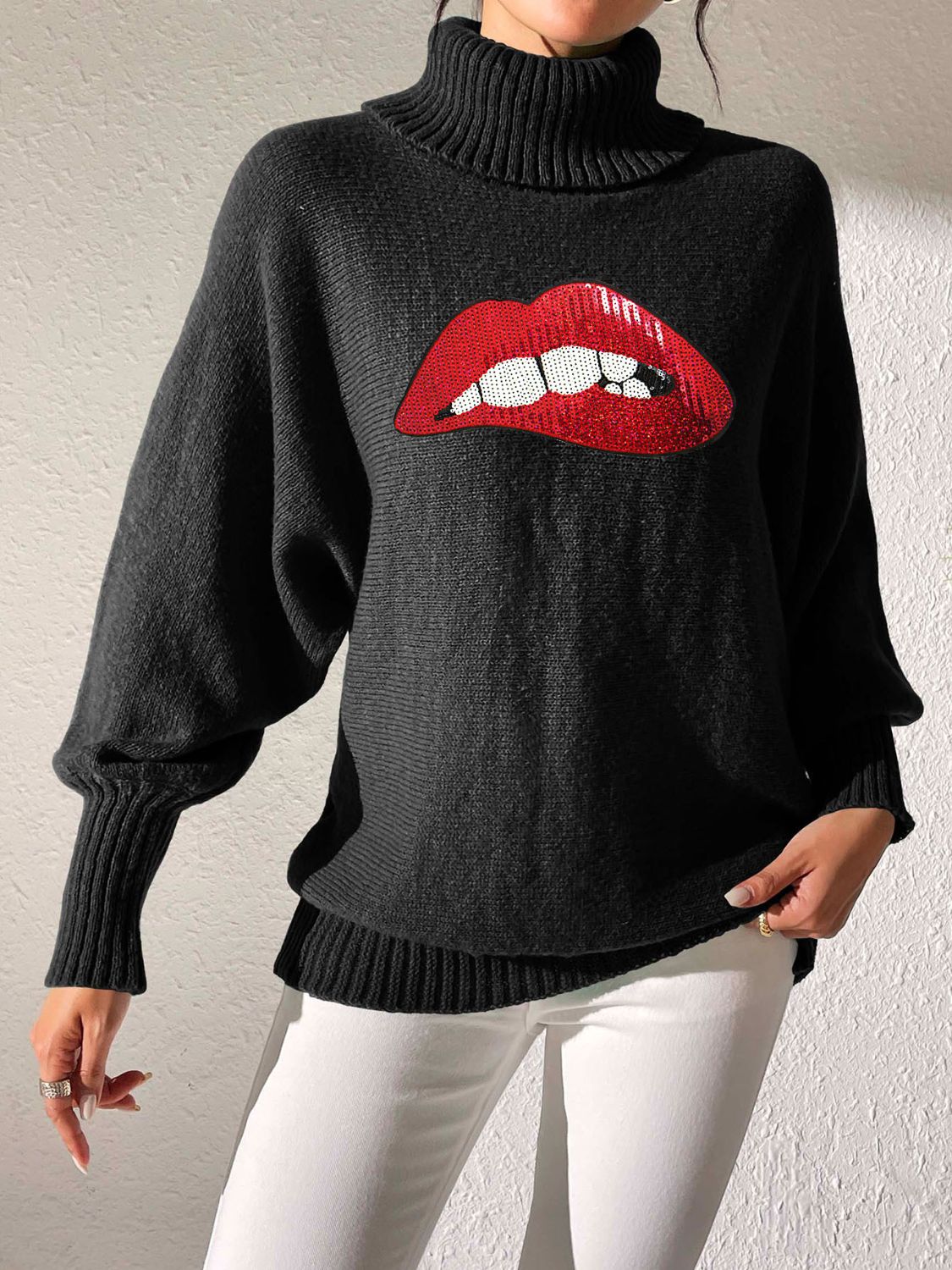 Black turtleneck sweater with sequin red lips detail and balloon sleeves.