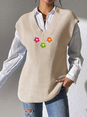 Beige ribbed knit vest with embroidered flowers and V-neck.