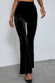 Black velvet hourglass flare trousers with a high waist.