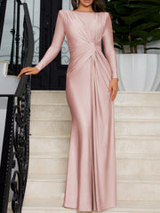 Pink ruched knot front maxi dress with long sleeves and a boat neckline.