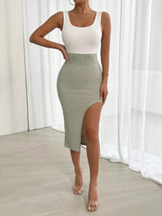 Asymmetrical midi dress with white tank top and sage green skirt with high slit.