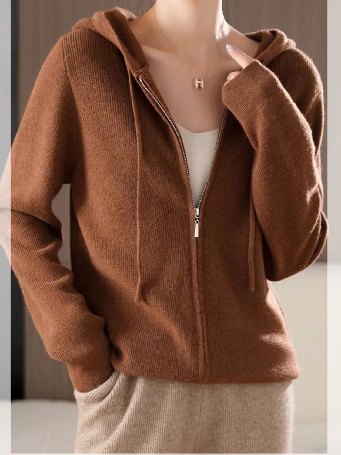 Ribbed knit zip-through hoodie in caramel with drawstring hood and full zip closure.