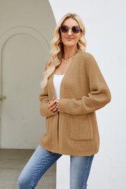 Caramel waffle knit raglan pocket cardigan with open front and long sleeves.