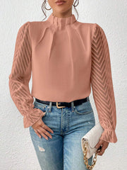 Burnt Coral Chevron Sleeve Ruffle Neck Blouse with sheer chevron sleeves and ruffled cuffs.