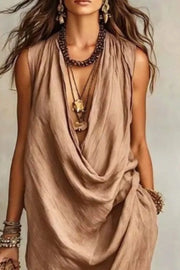 Tan cowl neck midi dress with pockets and a draped neckline.