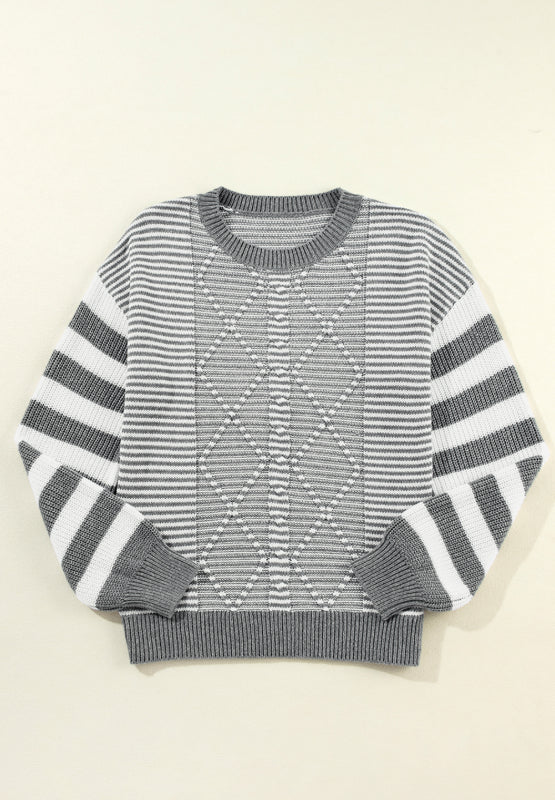 Gray and white striped knit sweater with diamond pattern detail.