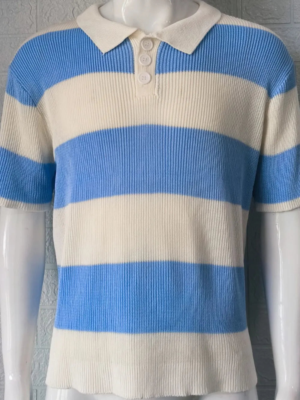 Sky blue and cream ribbed stripe knit polo shirt with short sleeves and button placket.