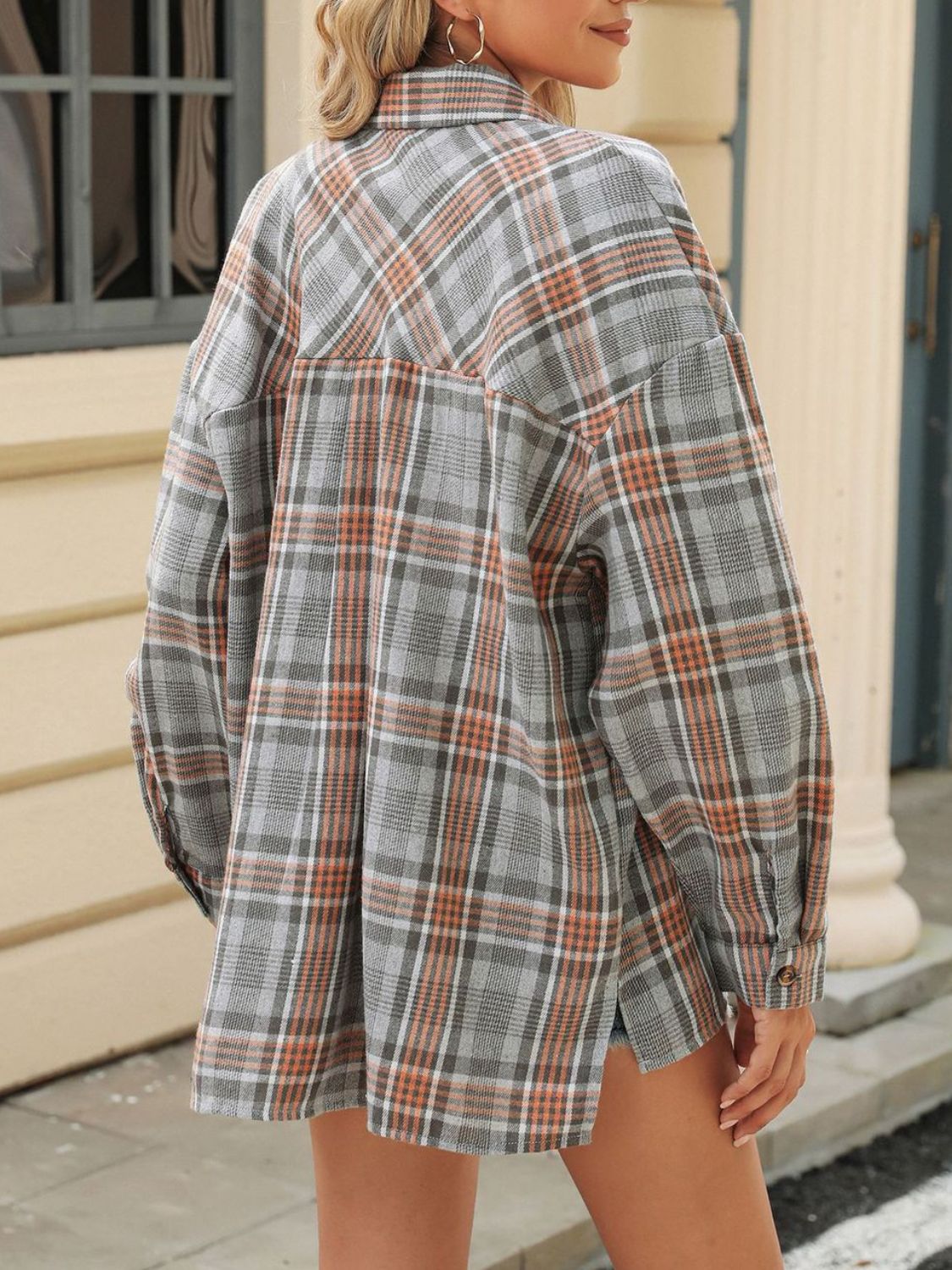 Gray plaid collared long sleeve shirt with button cuffs and a back yoke detail.