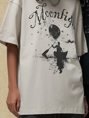 Ivory oversized tee with a black graphic of a person in a canoe under a moon and stars.
