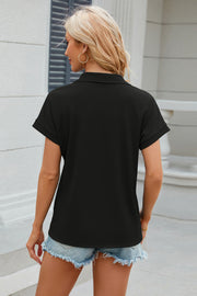 Black textured polo top with cuffed short sleeves and a collar.