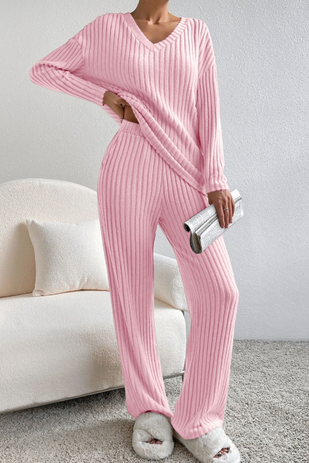 Blush pink ribbed V-neck loungewear set with long sleeves and wide-leg pants.