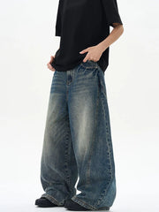 Oversized vintage-finish men's baggy jeans in dark blue denim with distressed details.