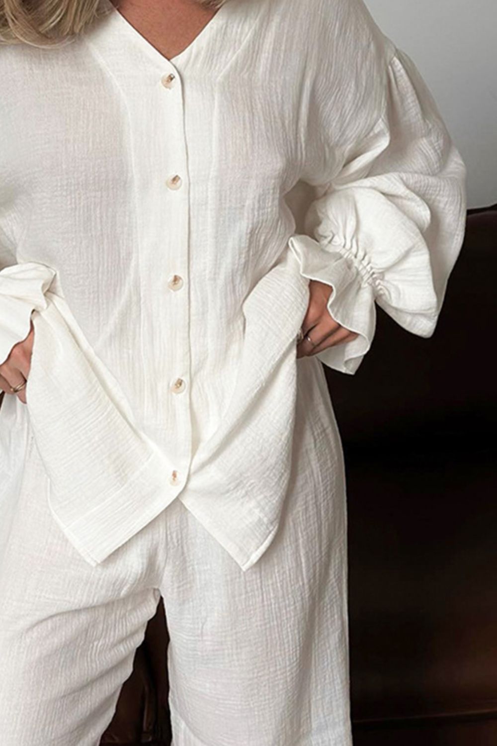 White gauze lounge set with voluminous buttoned sleeves and wide-leg pants.