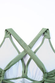 Sage ruched halter swim dress back with crisscross straps and tie detail.