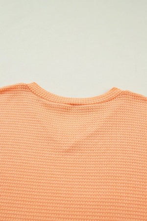 Waffle knit V-neck t-shirt in sherbet polyester with a ribbed neckline.
