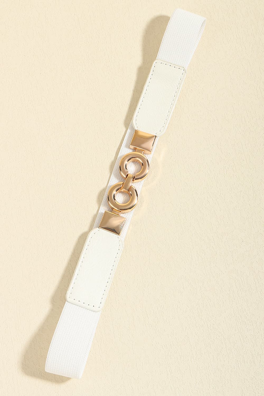 White elastic belt with gold interlocking rings and square buckle detail