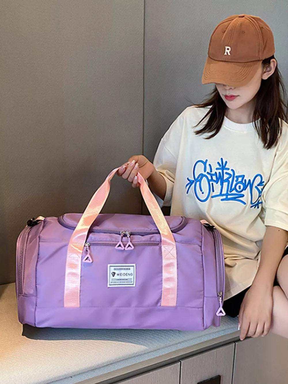 Taro Purple Oxford cloth duffle bag with pink straps and zippered compartments.