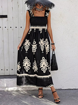 Black smocked square neck maxi dress with ornate print and ruffled straps.