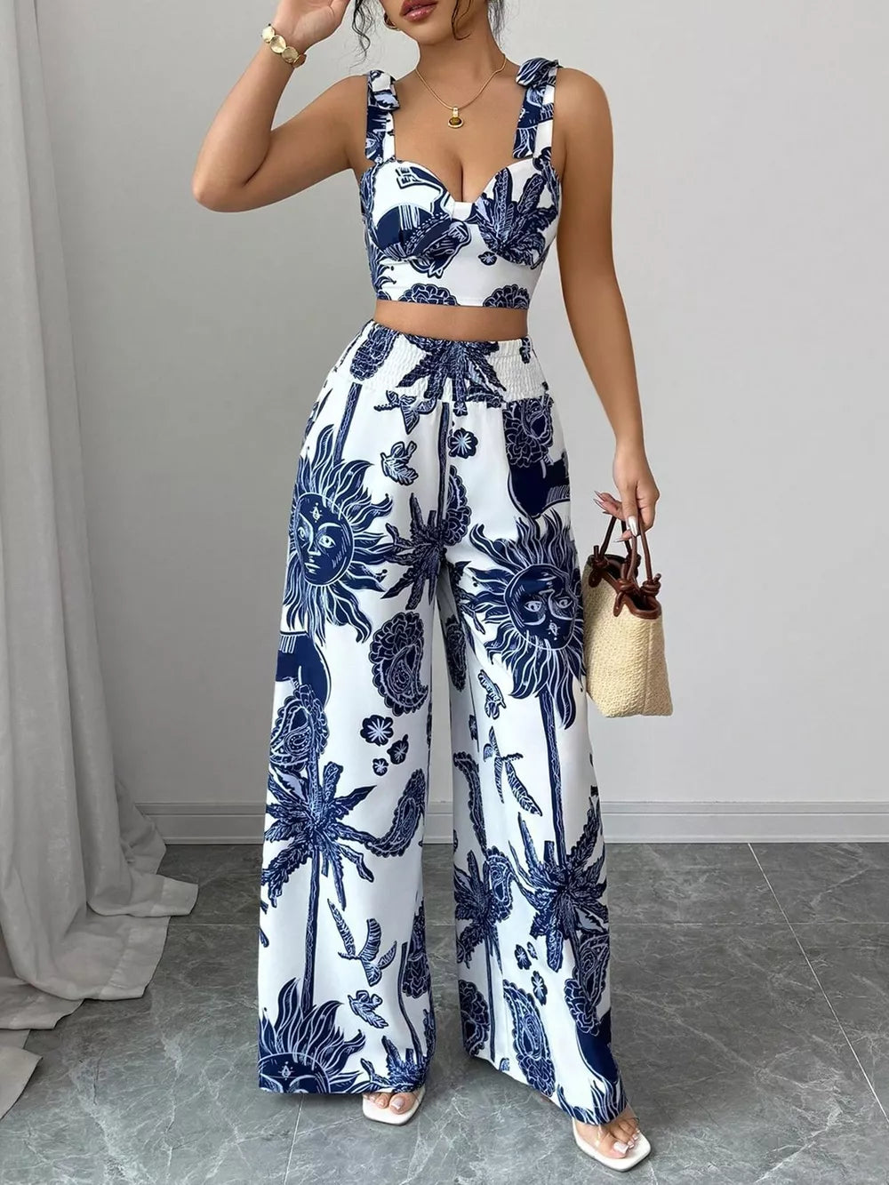 Blue tropical print crop top and wide-leg pants set with sweetheart neckline and smocked waist.