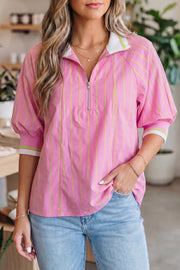 Pink striped half-zip polo shirt with white collar and neon green trim