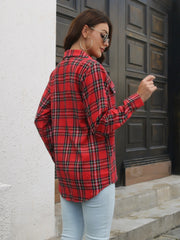 Red plaid overshirt with flap pockets and buttoned cuffs, worn with light wash jeans.